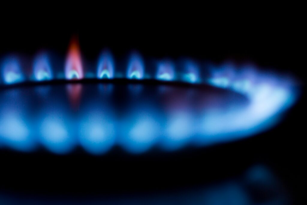Blurred image of a blue gas stove flame, highlighting heat and energy.